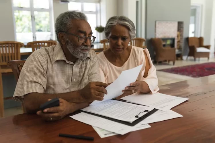 senior-couple-discussing-invoices-home_13339-369450